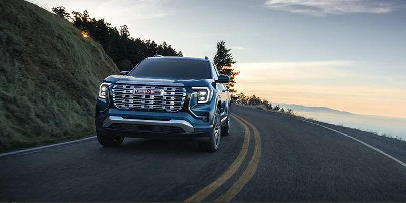 A 2026 GMC Terrain driving down the road.