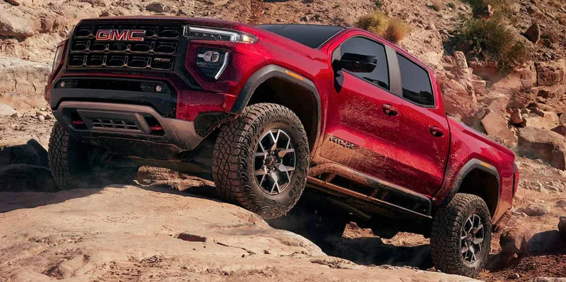 A red 2025 GMC Canyon off-roading.