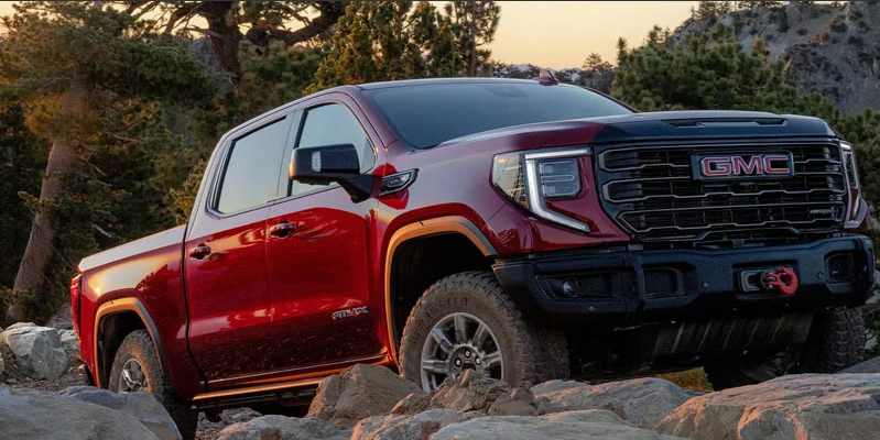 A close up of the passenger side of a 2026 GMC Sierra 1500 off-roading.