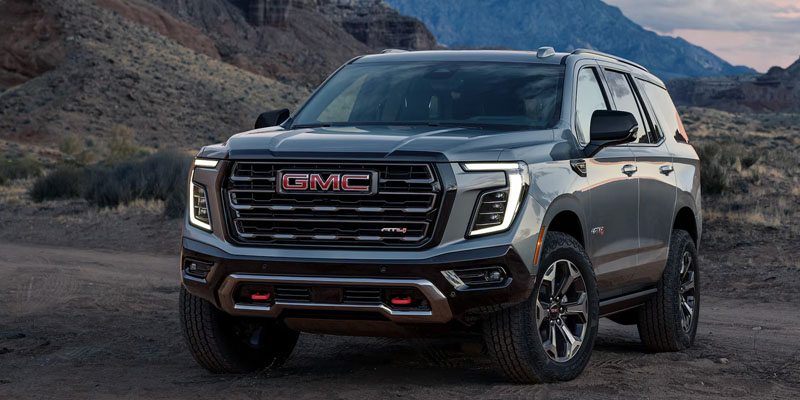 Grey 2026 GMC Yukon stopped by mountains showcasing stylish looks 