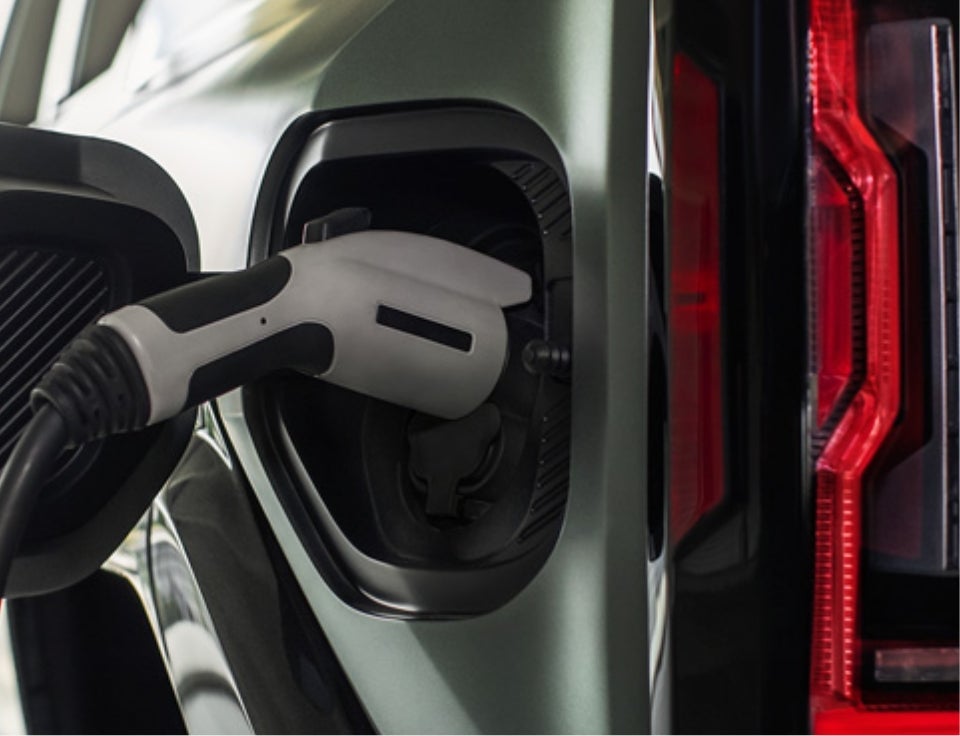 Close up of charging port with charger plugged in on a GMC Hummer EV SUV - Marquardt of Barrington GMC in Barrington IL